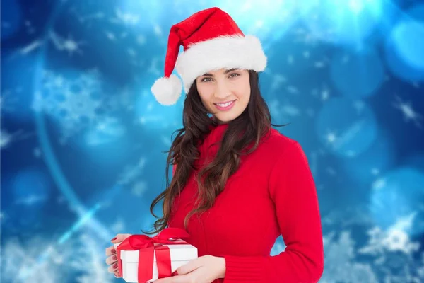 Noel Baba şapkalı kadın Noel hediyesi taşıyor. — Stok fotoğraf