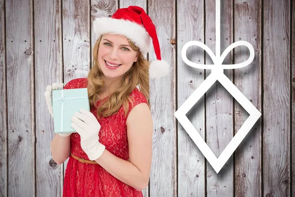 Femme en chapeau de Père Noël tenant un cadeau de Noël — Photo