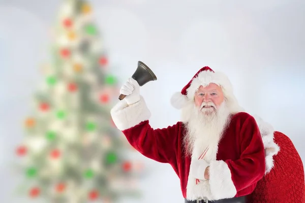 Papai Noel segurando saco de presente e campainha tocando — Fotografia de Stock