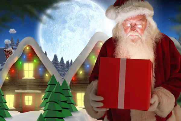 Санта Клаус смотрит на рождественский подарок — стоковое фото
