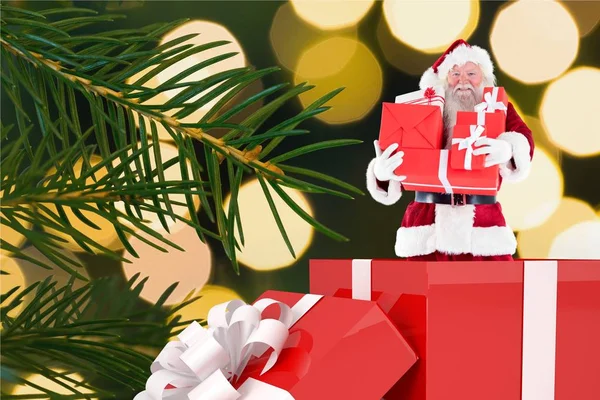 Santa claus figurine with christmas gifts — Stock Photo, Image