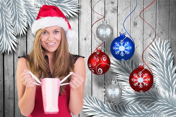 Woman in santa hat holding a bag — Stock Photo, Image