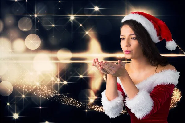 Woman wearing santa costume blowing kiss — Stock Photo, Image