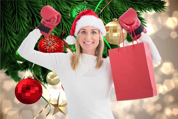 Kvinna i santa hatt och boxning handskar — Stockfoto