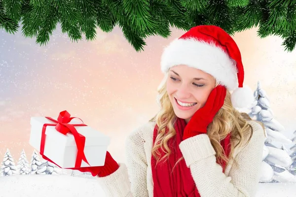 Woman in santa hat holding a gift box — Stock Photo, Image