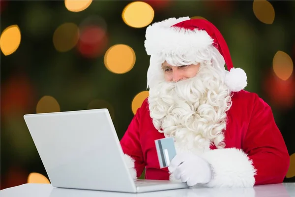 Santa claus gör online shopping — Stockfoto