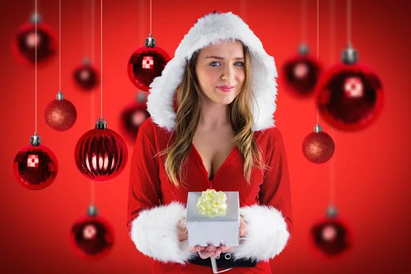 Woman in santa costume holding a gift — Stock Photo, Image