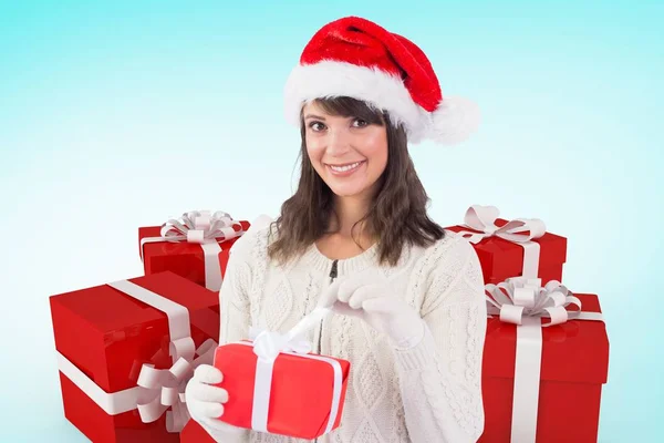 Woman in santa hat holding christmas gifts — Stock Photo, Image