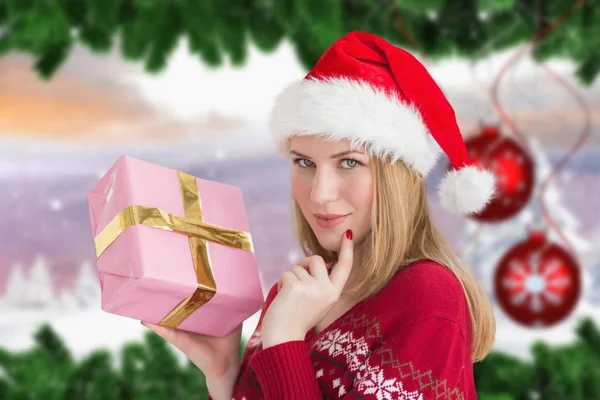 Woman in santa hat holding a gift box — Stock Photo, Image