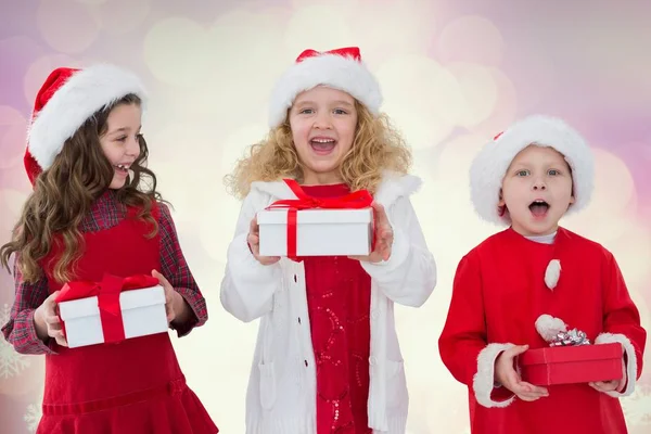 Excited kids holding their gift boxes — Stock Photo, Image