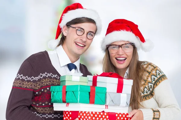 Pareja en santa hat celebración de regalos de Navidad —  Fotos de Stock