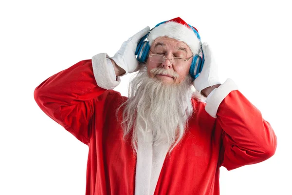 Santa claus poslechu hudby ve sluchátkách — Stock fotografie