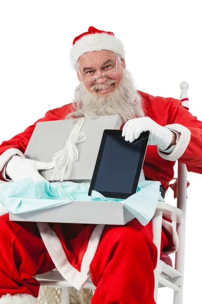 Santa claus removing tablet from gift box — Stock Photo, Image