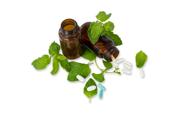 Medicine bottle with mint leaves — Stock Photo, Image