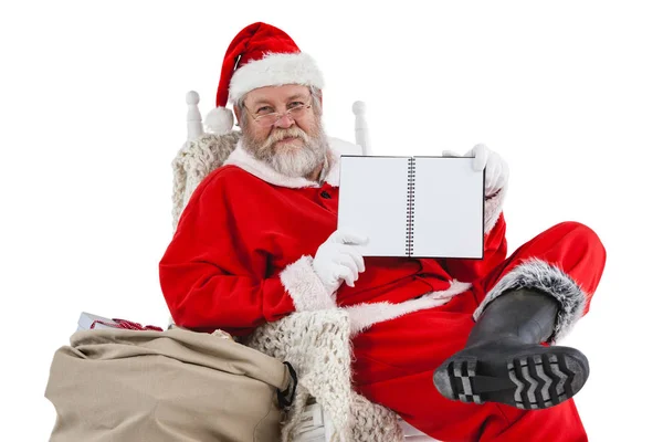Santa claus holding a diary — Stock Photo, Image