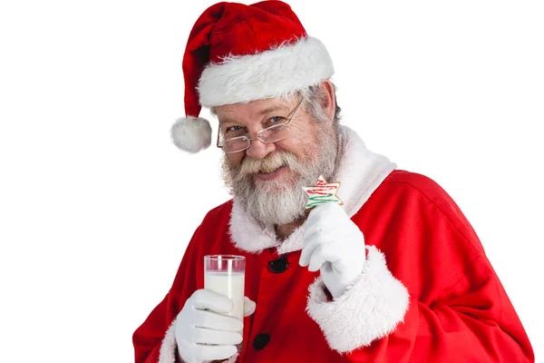 Santa claus drží Sklenka mléka — Stock fotografie