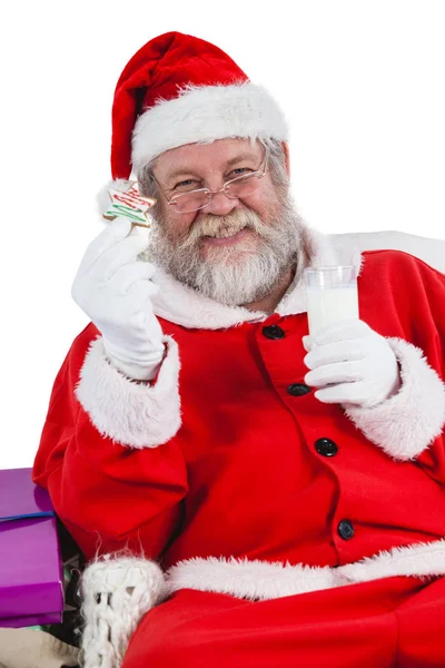 Santa claus having milk and cookies — Stock Photo, Image