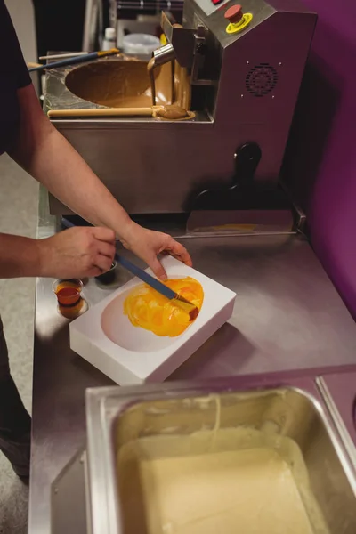 Worker painting a chocolate mould — Stock Photo, Image