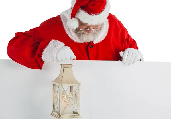 Santa claus holding christmas lantern — Stock Photo, Image