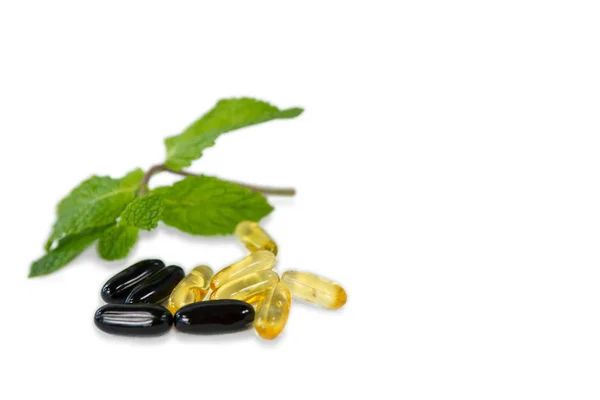 Capsules with mint leaves — Stock Photo, Image