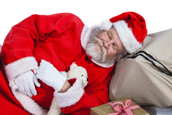 Weihnachtsmann schläft neben Weihnachtsgeschenk — Stockfoto