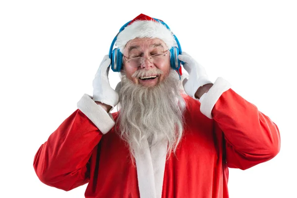 Santa claus écoute de la musique sur écouteurs — Photo