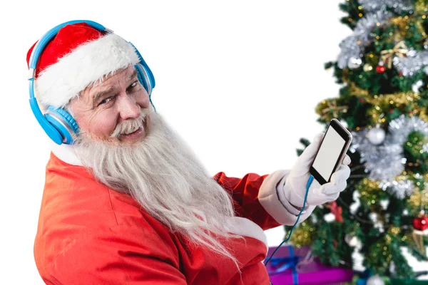 Santa Claus escuchando música en los teléfonos — Foto de Stock