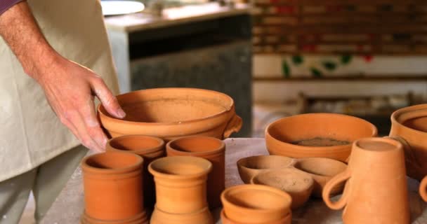 Potter checking bowl in pottery workshop — Stock Video