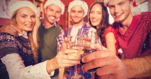 Friends wearing Christmas hats — Stock Photo, Image