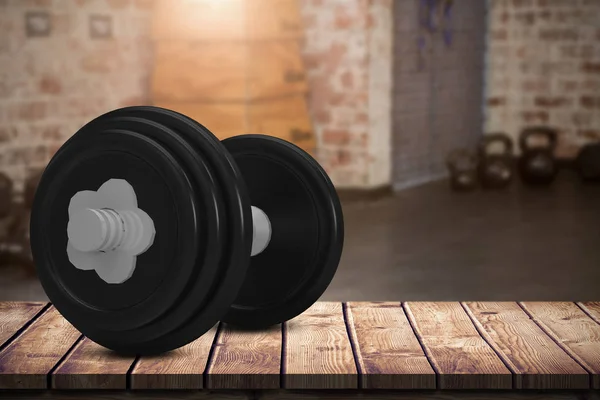 Black dumbbell on wooden table — Stock Photo, Image
