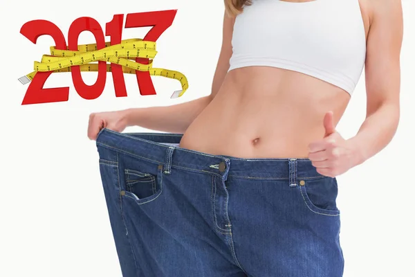 Woman wearing old pants after losing weight — Stock Photo, Image