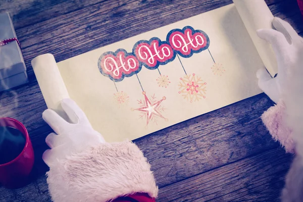 Santa claus opening scroll — Stockfoto