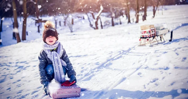 Cute boy picking up present — Stock Photo, Image