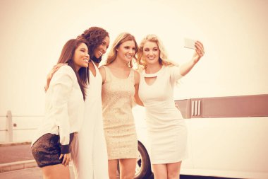 Women taking selfie next to limousine clipart