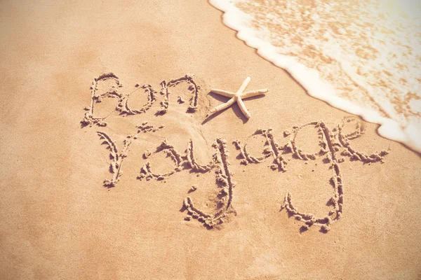 Bon voyage written on sand — Stock Photo, Image