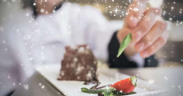 Chocolate cake getting finishing touch — Stock Photo, Image