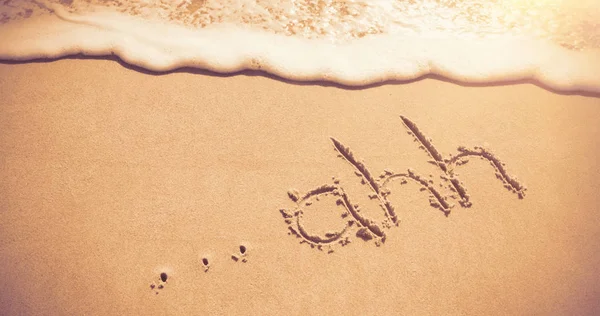 Ahh geschrieben auf Sand am Strand mit Wellen — Stockfoto