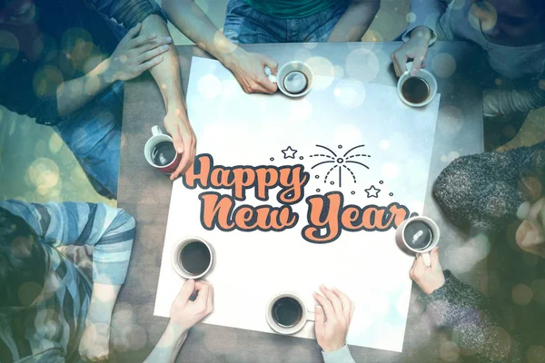 People around table with new year graphic — Stock Photo, Image