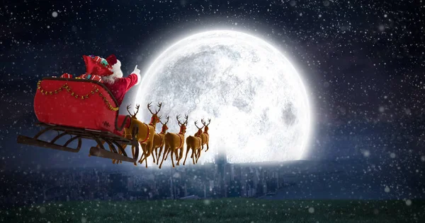 Santa Claus riding on sled with gift boxes — Stock Photo, Image