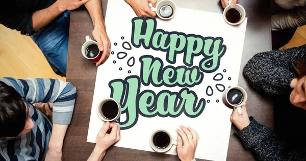 People around table with new year graphic — Stock Photo, Image