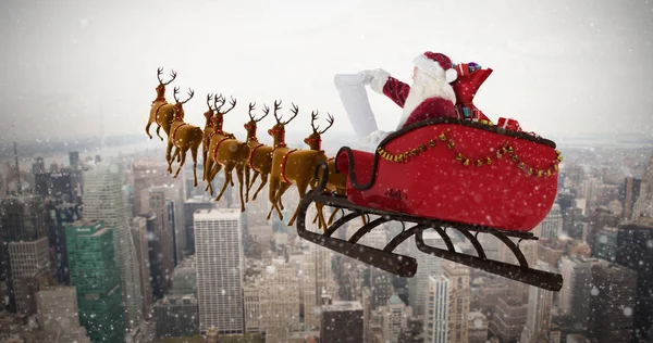 Santa Claus riding on sled during Christmas — Stock Photo, Image