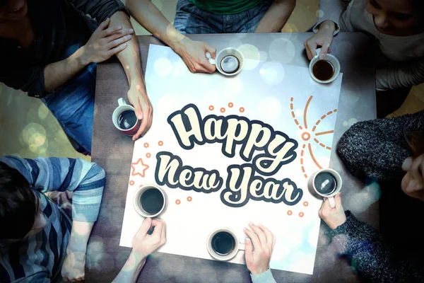 Mensen rond de tafel met Nieuwjaar afbeelding — Stockfoto
