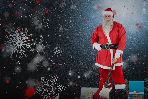 Papai Noel de pé com guitarra e presentes — Fotografia de Stock