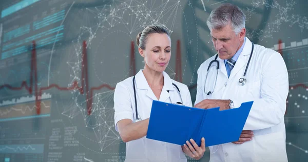 Composite image of male and female doctors discussing over notes — Stock Photo, Image