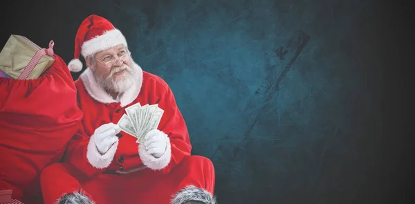 Santa claus počítání bankovek — Stock fotografie