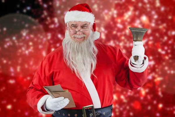 Santa claus holding envelopes and bell — Stock Photo, Image