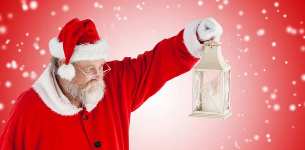 Santa claus tittar på Jul lykta — Stockfoto