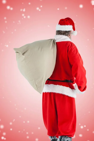 Noel Baba hediye çuval içinde taşıma — Stok fotoğraf