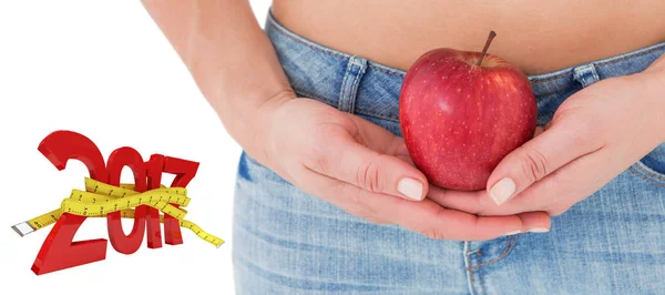 Fit woman standing with red apple — Stock Photo, Image