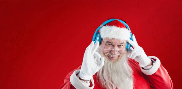 Santa claus listening to music on headph — Stock Photo, Image